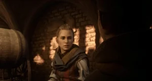 Escena de un videojuego con ambientación medieval: una joven con expresión seria habla con otra persona en una bodega de piedra iluminada por luz cálida.