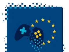 Ilustración vectorial minimalista de un mando de videojuego azul oscuro partido en dos, cuyos fragmentos se desintegran en píxeles; a la derecha, el mando está rodeado por un círculo de doce estrellas amarillas que representan la Unión Europea, todo sobre un fondo azul con bordes también pixelados.