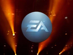 EA anuncia colaboración con Stability AI para desarrollar juegos con inteligencia artificial Logotipo de Electronic Arts (EA) iluminado en un escenario oscuro con focos naranjas apuntando hacia arriba.